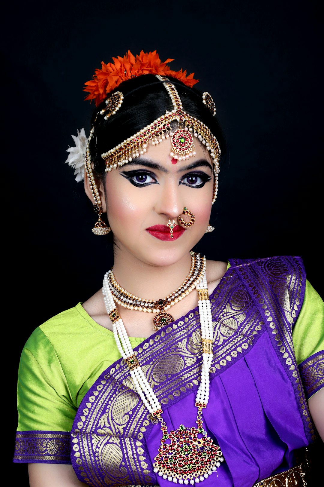 Woman in a purple and green traditional Maharashtrian saree