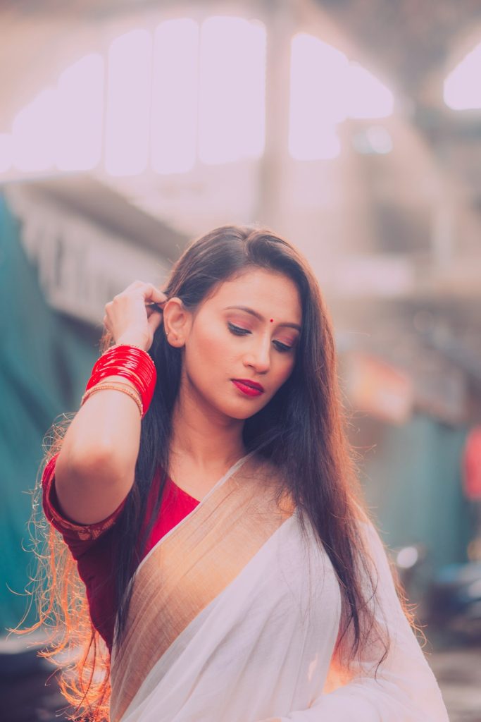 Girl in a traditional Bengali saree at golden hour, Bengali saree captions